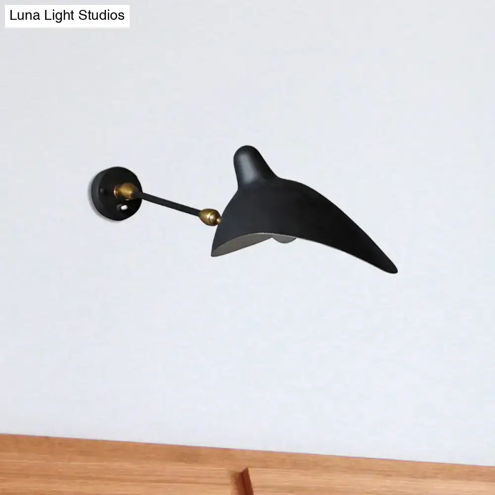 Modern black and brass duckbill wall lamp with metallic shade and sleek curved design ideal for living room fixture height