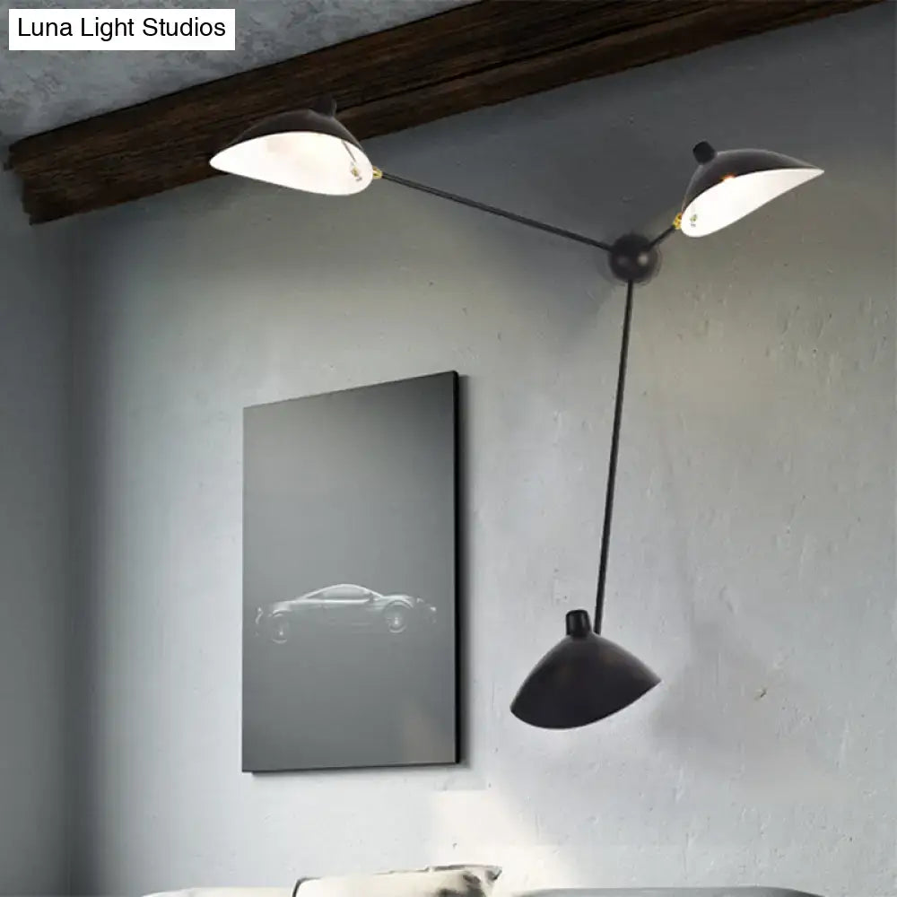 Modern black and brass wall lamp with metallic shades and fixture height featuring two upward and one downward conical shade
