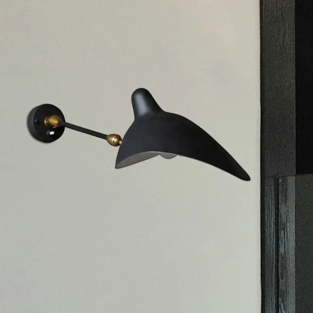 Modern black and brass wall lamp with metallic shade and sleek curved duckbill design for living room fixture height