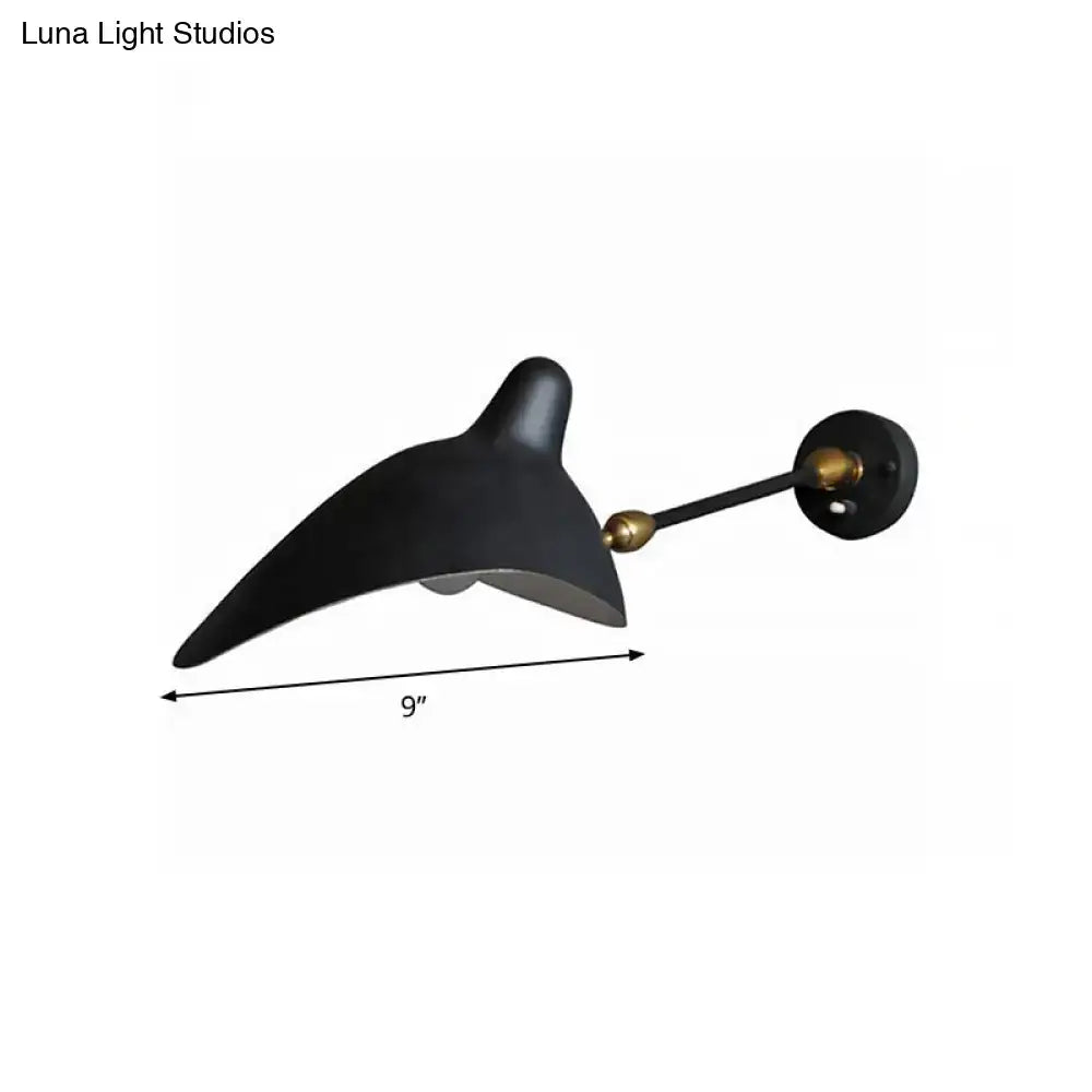 Modern black and brass wall lamp with metallic shade and sleek curved design featuring fixture height details