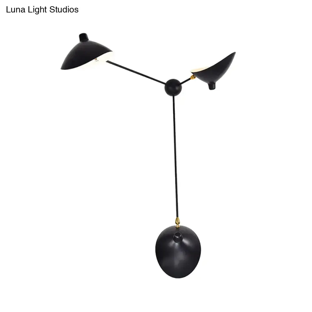 Modern black and brass wall lamp with three sculptural heads and metallic shade featuring adjustable fixture height