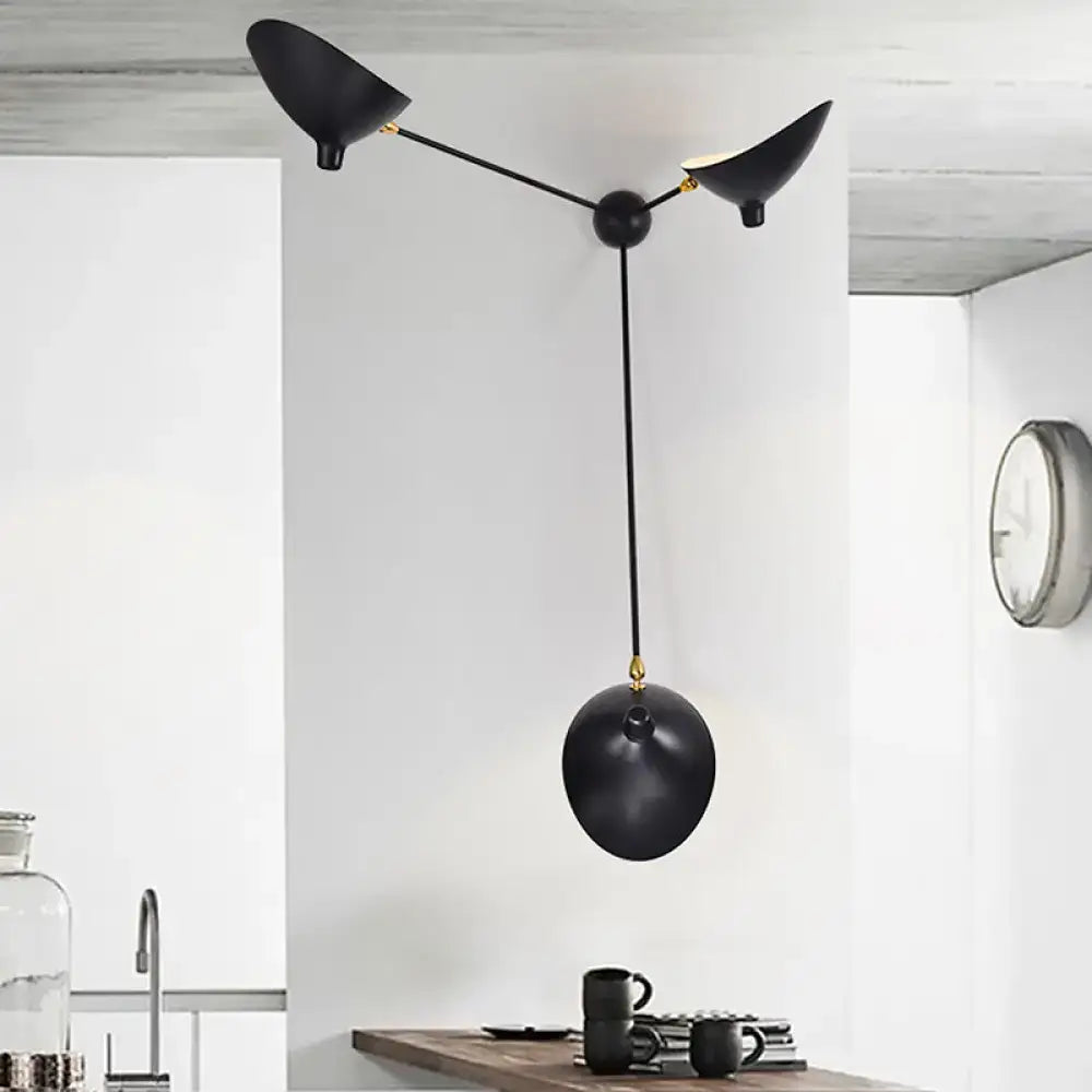 Modern black and brass wall lamp with three angular metallic shade fixtures and central spherical element for living room