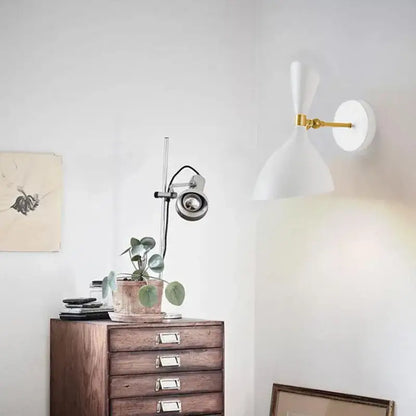 Modern black and brass industrial wall lamp with a white wall sconce and gold articulated arm for living room decorbites black white