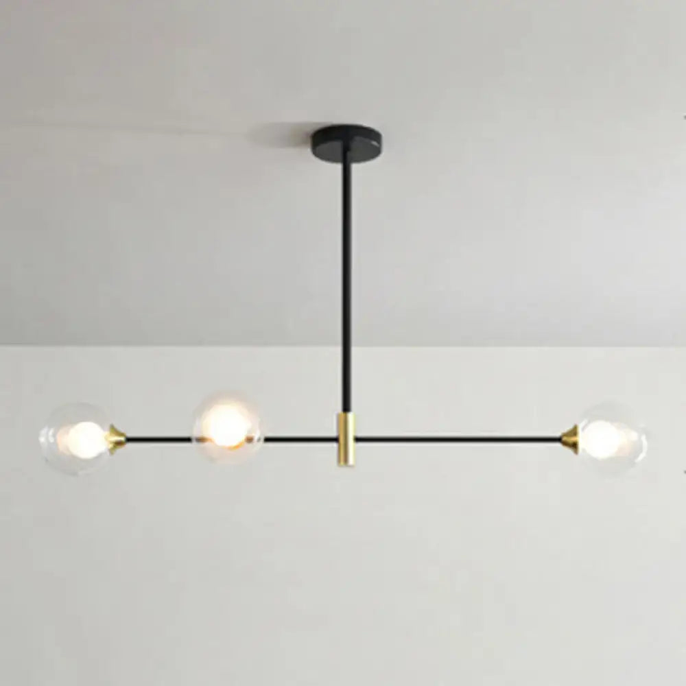 Modern black and brass metal island pendant chandelier with three clear glass globes and adjustable chain cord length