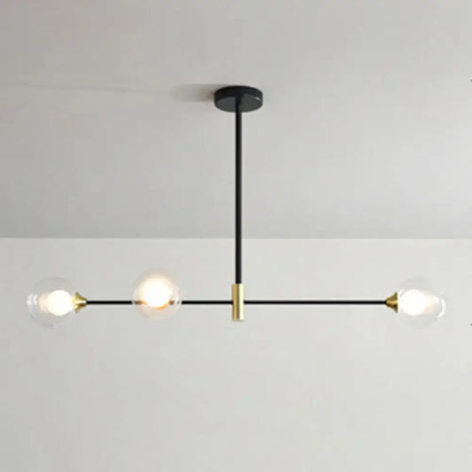 Modern black and brass metal island pendant chandelier with three clear glass globes and adjustable chain cord length