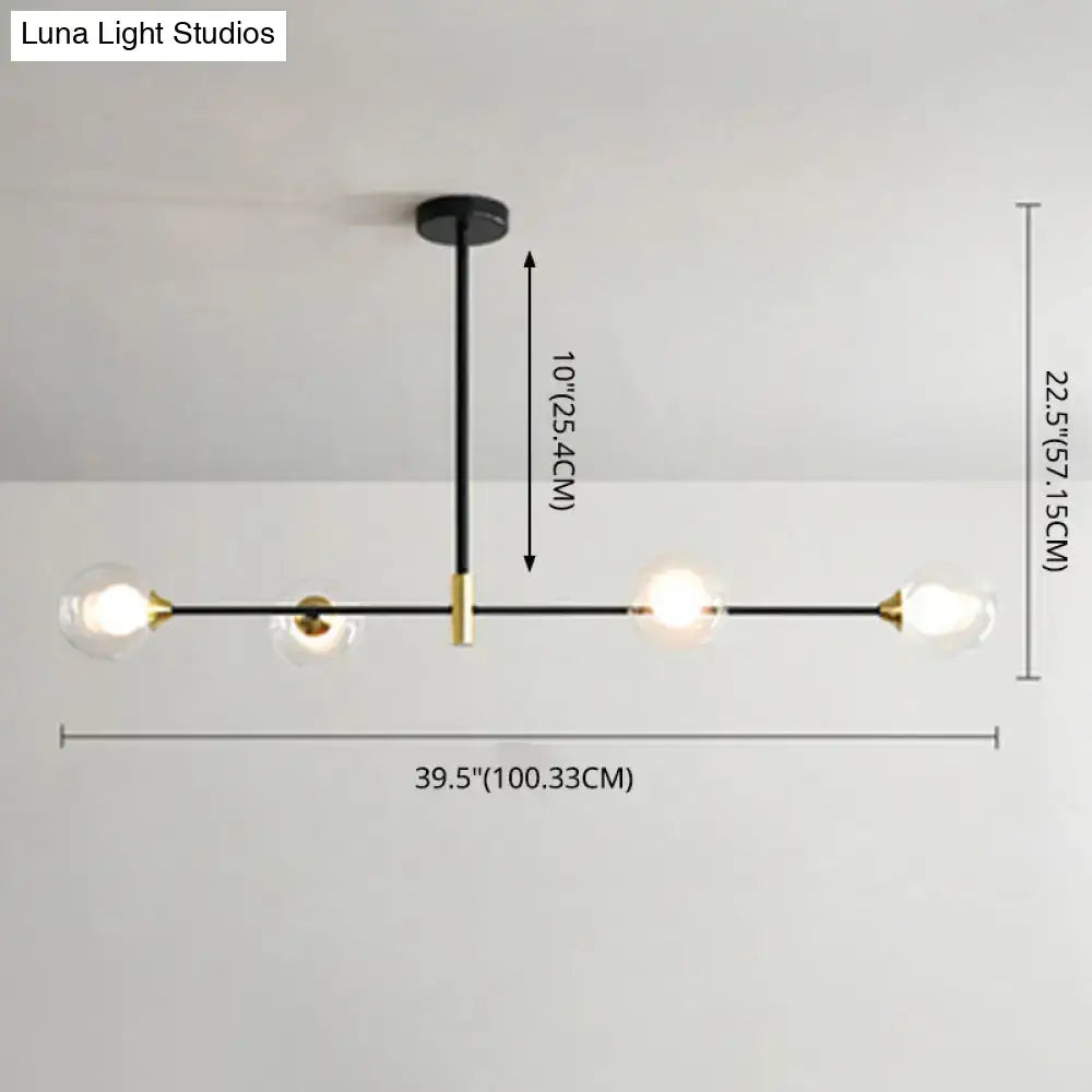 Modern black metal island pendant chandelier with brass accents and four clear glass globe bulbs with chain cord length