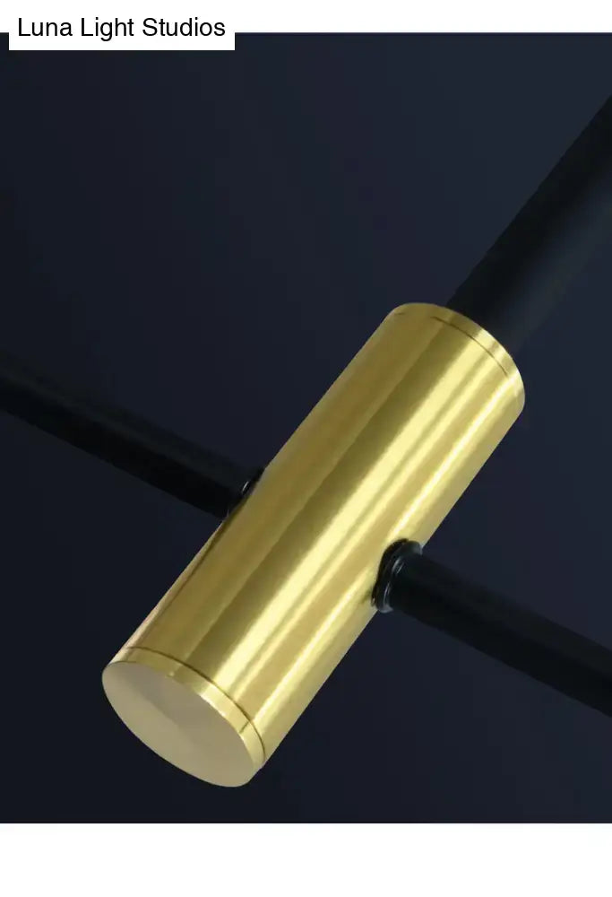 Gold-colored cylindrical connector with polished finish on modern black metal island pendant chain cord length adjuster