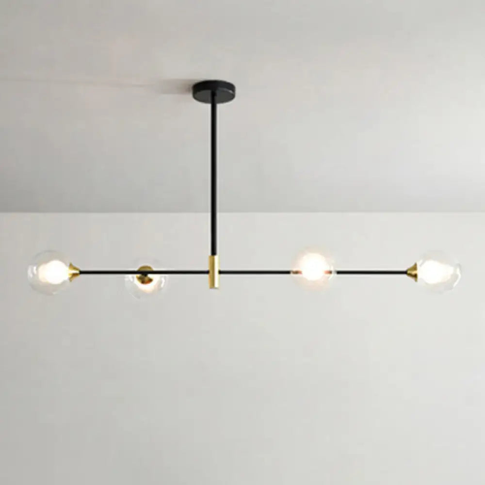 Modern black metal island pendant chandelier with brass accents and four clear glass globe bulbs featuring chain cord length