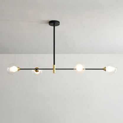 Modern black metal island pendant chandelier with brass accents and four clear glass globe bulbs featuring chain cord length