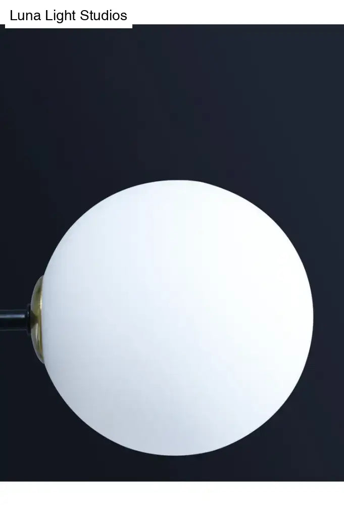 Modern black metal island pendant with white frosted glass globe lampshade and brass fixture for dining room chandelier