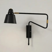 Modern black and brass wall-mounted reading lamp with a sleek retractable arm for bedroom lighting