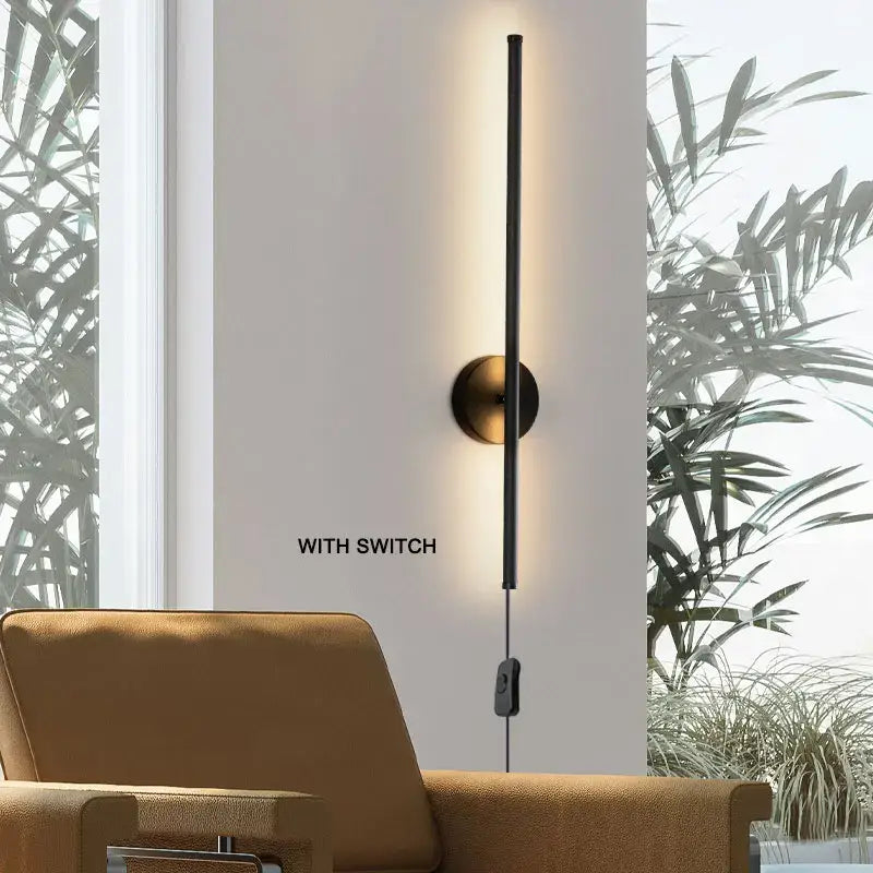 Modern black and brass rotation led wall light with sleek vertical design and brushed brass circular base for living room sconce