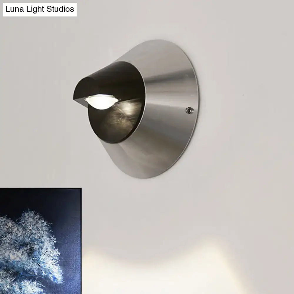 Modern black and brushed steel wall light with a sleek conical design and frosted glass diffuser for corridors