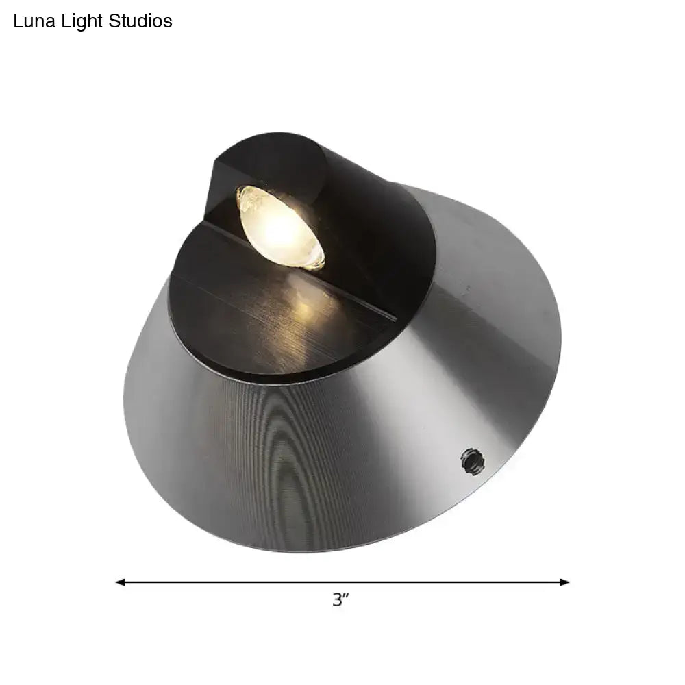 Modern black and brushed steel conical wall light with sleek design for outdoor pathway and corridor use