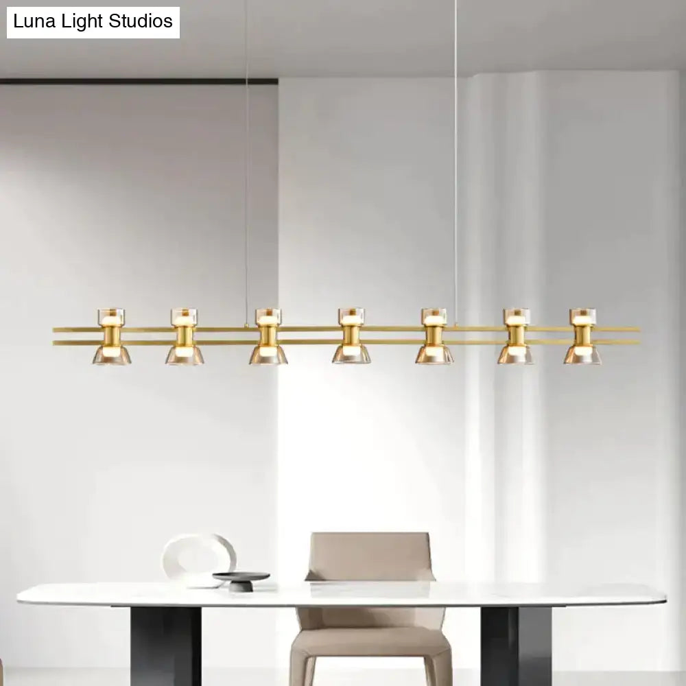 Gold-toned modern pendant led strip lamp with six cylindrical fixtures on a sleek horizontal bar for kitchen island lighting