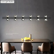 Modern black and chrome linear led strip lamp with five chrome spotlight fixtures for kitchen island lighting