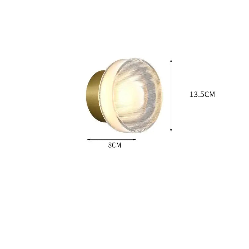 Modern black and clear acrylic wall sconce light with brass finish and frosted glass diffuser for bedroom lighting