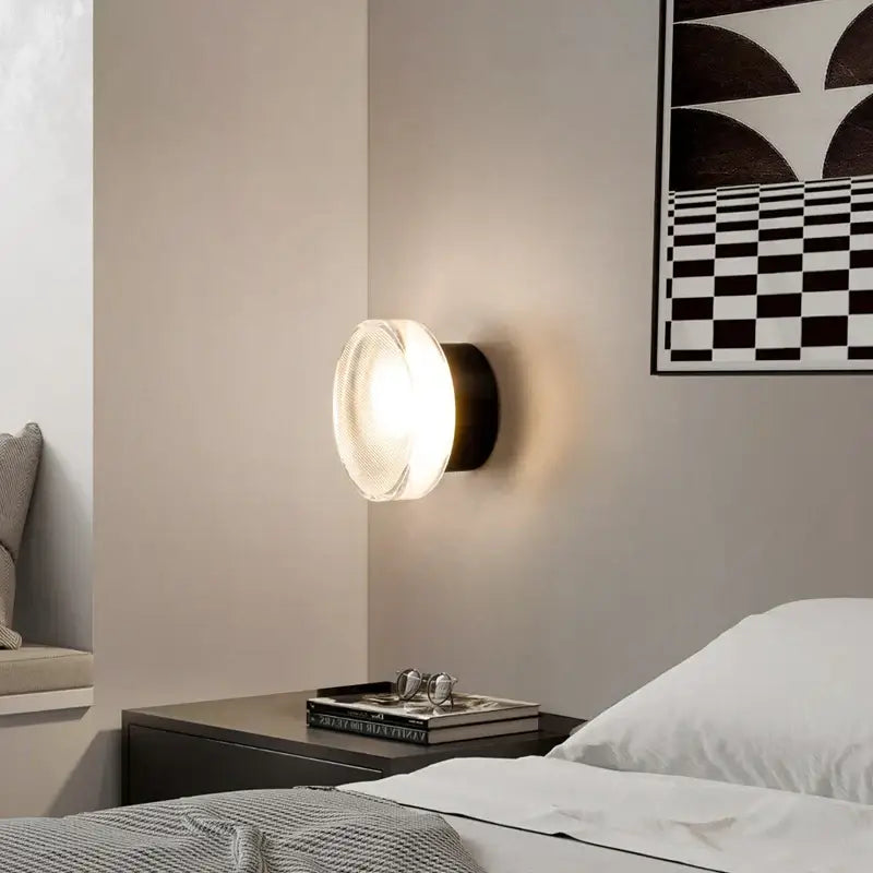 Modern black wall sconce light with frosted glass diffuser and matte metal base for bedroom lighting