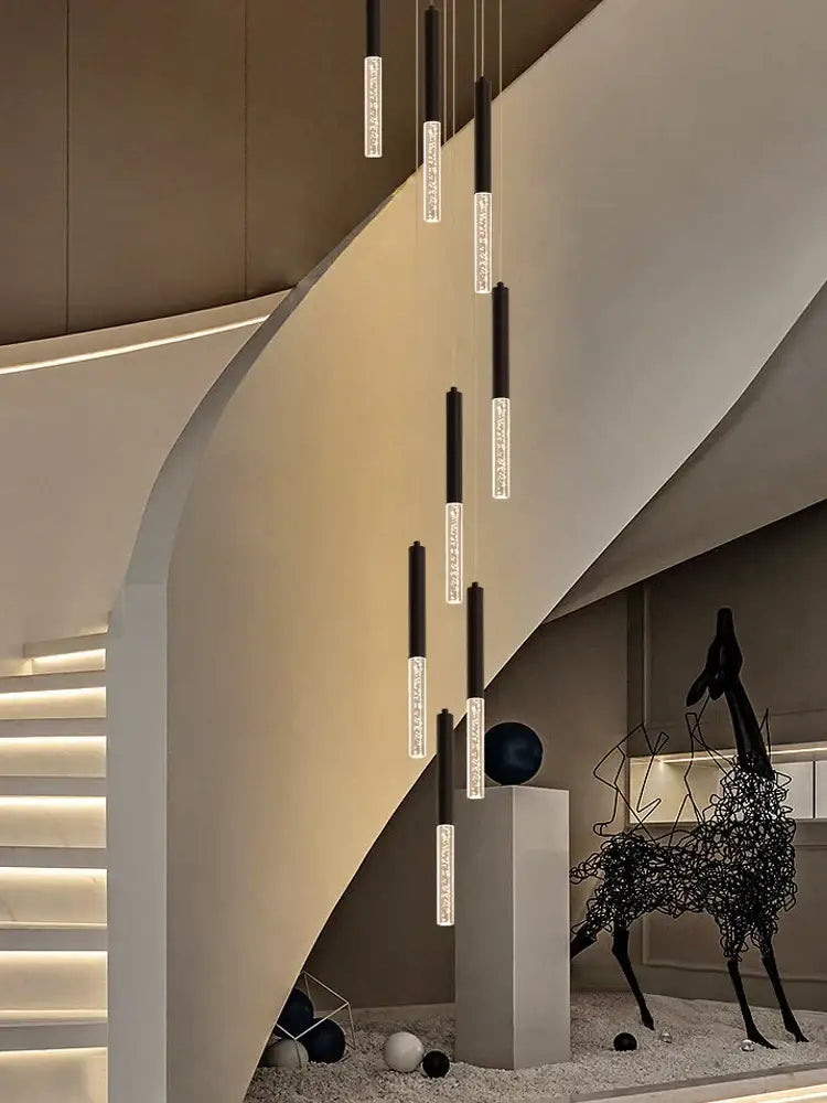 Modern black and clear glass cylindrical chandelier with illuminated pendant lights in a cascading decorbites cylindrical design