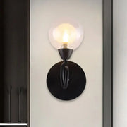 Modern black wrought iron wall lamp with clear glass globe light fixture for living room illumination