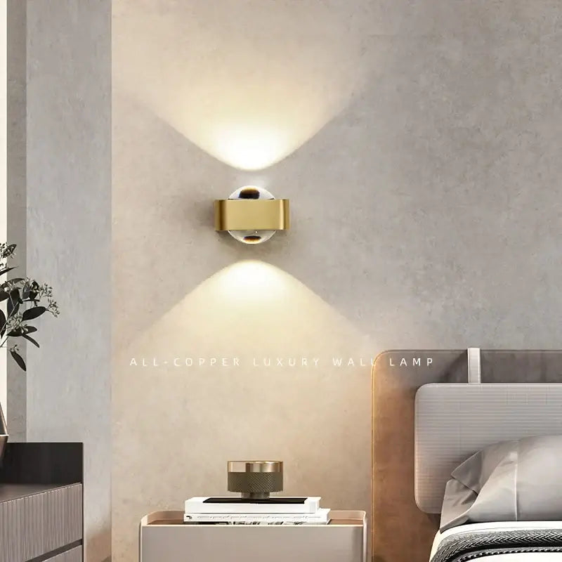Modern black and copper bedroom wall lamp with gold-colored all-copper design and dual upward-facing light beams decorbites copper bedroom wall