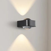 Modern black and copper bedroom wall lamp with a sleek angular design and clear glass dome by decorbites copper bedroom