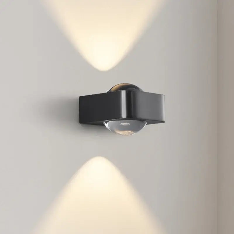 Modern black and copper bedroom wall lamp with a sleek angular design and clear glass dome by decorbites copper bedroom