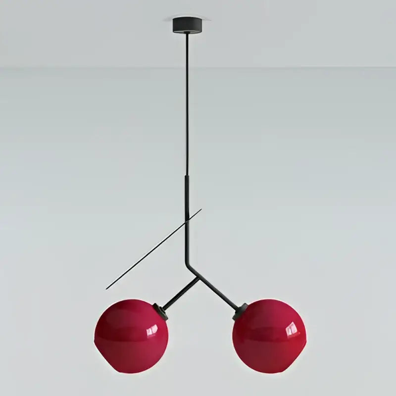 Modern black and crimson glass cherry pendant light featuring red spherical glass cherry pendant with black metal frame