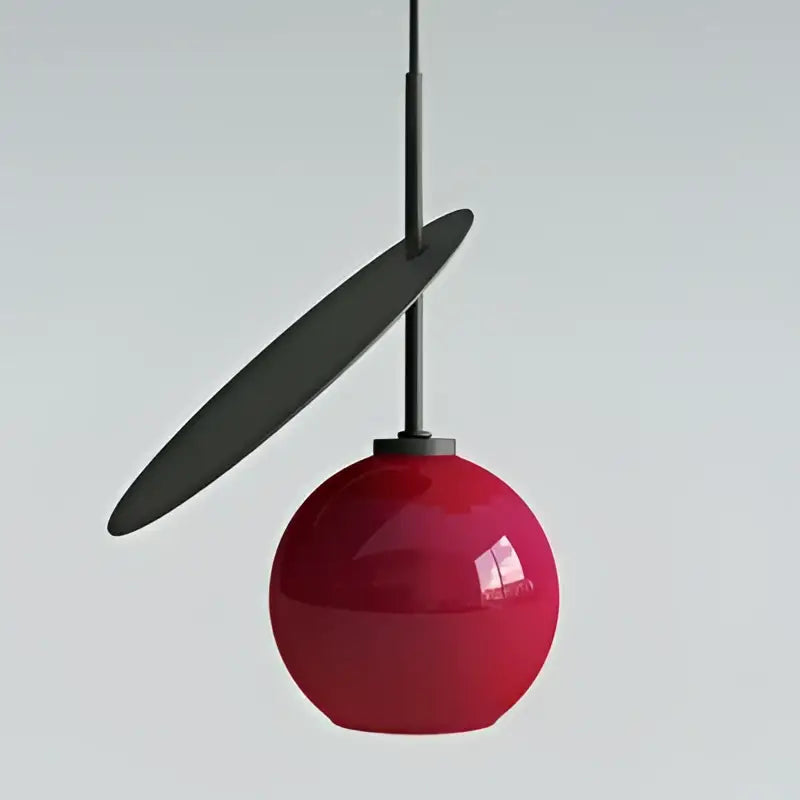 Modern black and crimson glass cherry pendant light with a glossy red sphere and matte black disc accent for dining room decorbites glass cherry