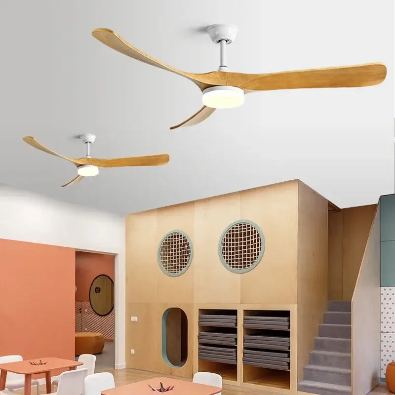 Modern ceiling fan with three light wooden blades and white housing in black and dark brown wooden ceiling design