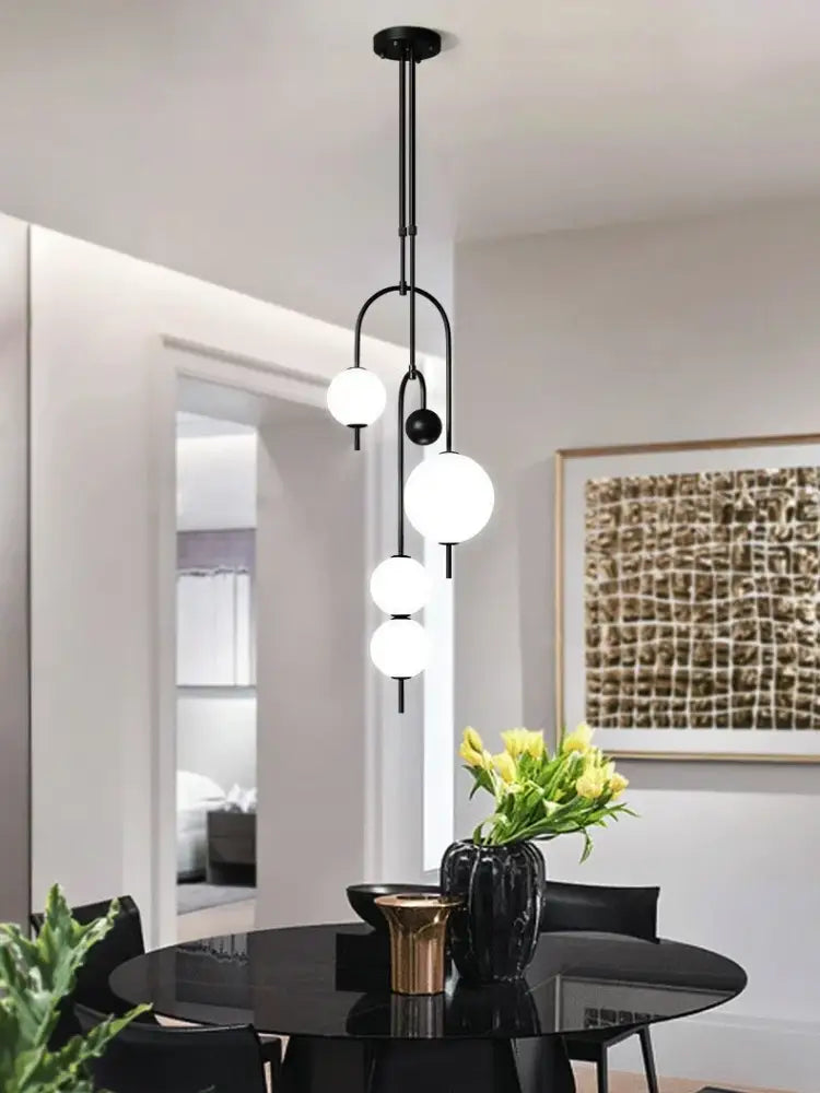 Modern black ceiling pendant with three frosted glass bulbs and one small black accent bulb for glass suspension kitchen decorbites