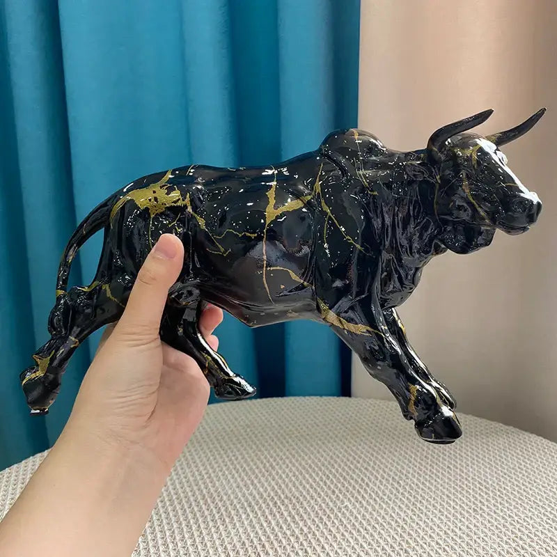 Modern black and gold decorbites bull statue ceramic figurine with gold splatter accents for living room decor