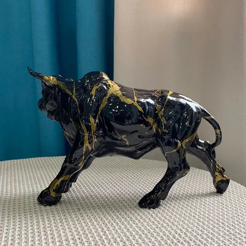 Modern black and gold ceramic bull statue with marble-like streaks for living room decor by decorbites bull statue
