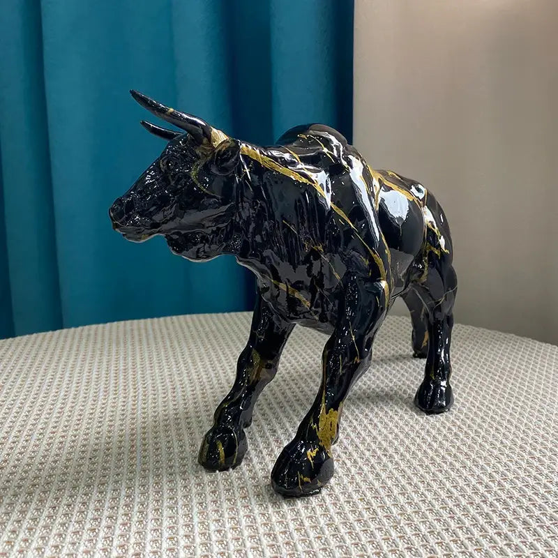 Modern black and gold decorbites bull statue ceramic figurine with glossy finish and marble-like streaks for living room decor