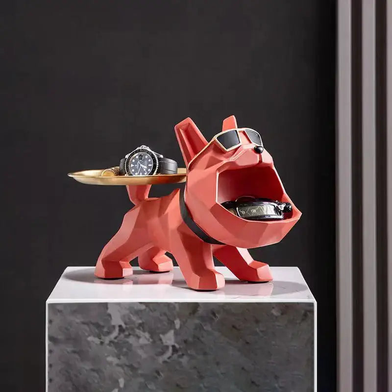 A vibrant coral geometric dog figurine with sunglasses and black collar serving as a bulldog butler tray for home decor