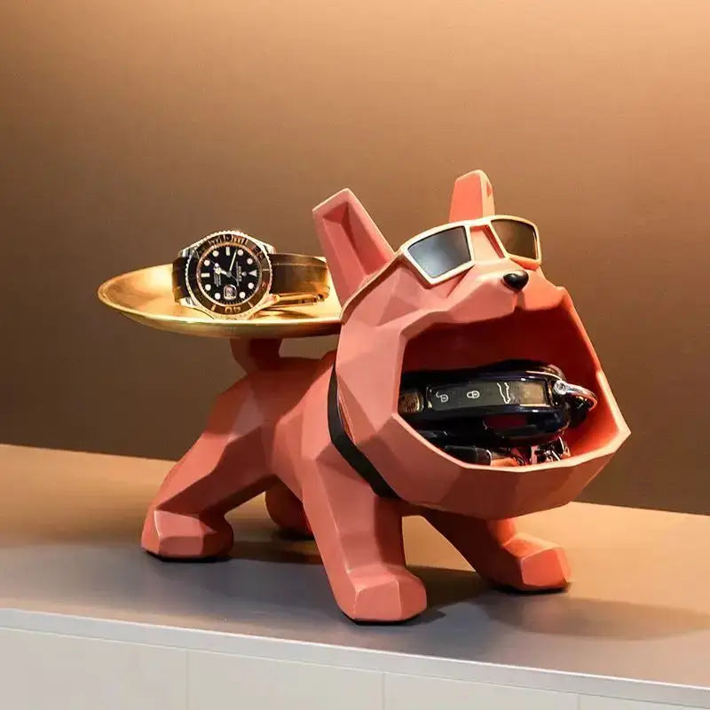 A pink geometric bulldog butler tray with sunglasses and collar holding keys and watch for home decor storage