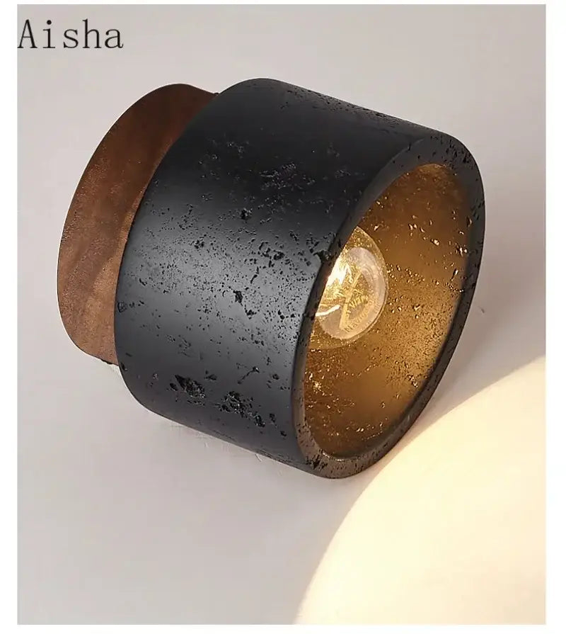 Modern black and gold cave stone ceiling chandelier featuring a textured cylindrical wall sconce with rustic finish decorbites cave stone