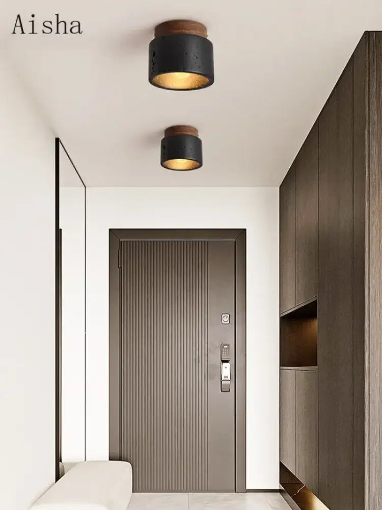 Modern black and gold cave stone ceiling chandelier with black cylindrical lights and wooden top accents by decorbites cave stone