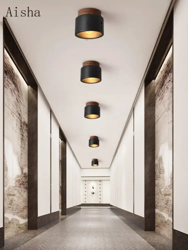 Modern black and gold cave stone ceiling chandelier with wooden accents and warm gold interiors by decorbites cave stone