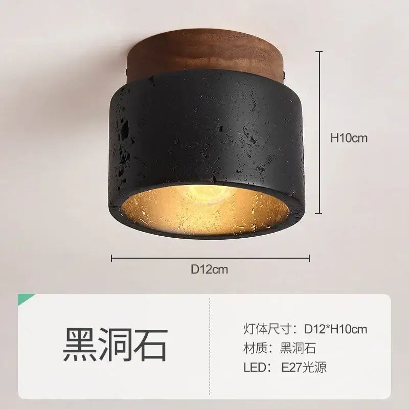 Modern black and gold cave stone ceiling chandelier with concrete texture and warm golden glow decorbites cave stone