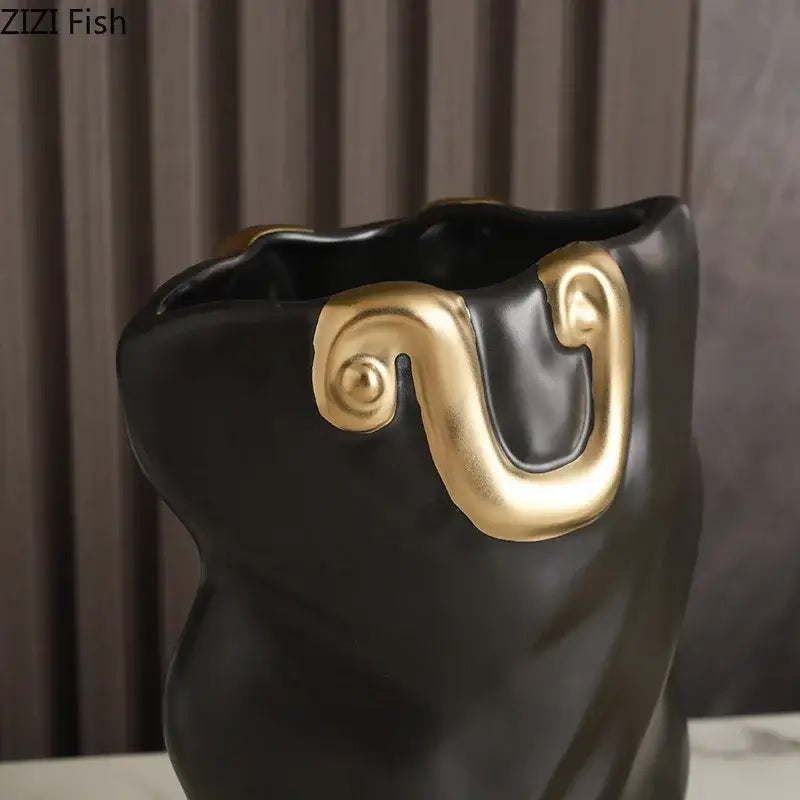 Modern black and gold ceramic bag vase with glossy finish and ornate gold handle for living room decor by decorbites ceramic