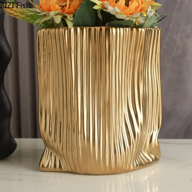 Modern black and gold decorbites ceramic bag vase with golden vertical ribbed texture and tree trunk design for living room decor