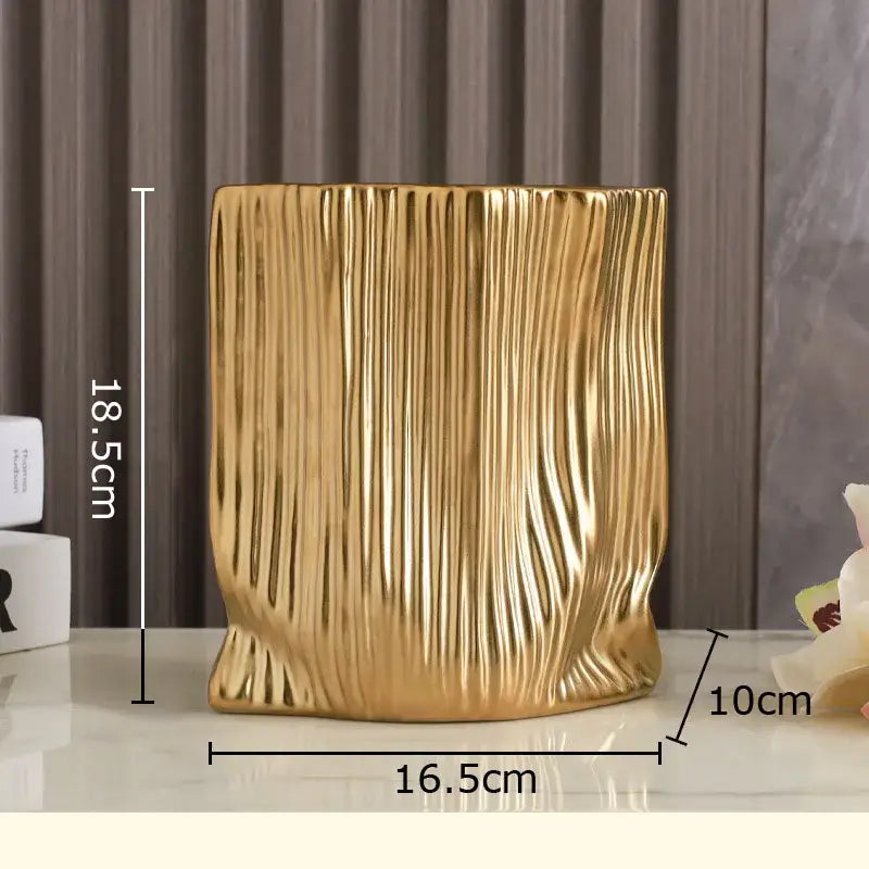 Modern black and gold decorbites ceramic bag vase with golden vertical ribbed texture for living room decor