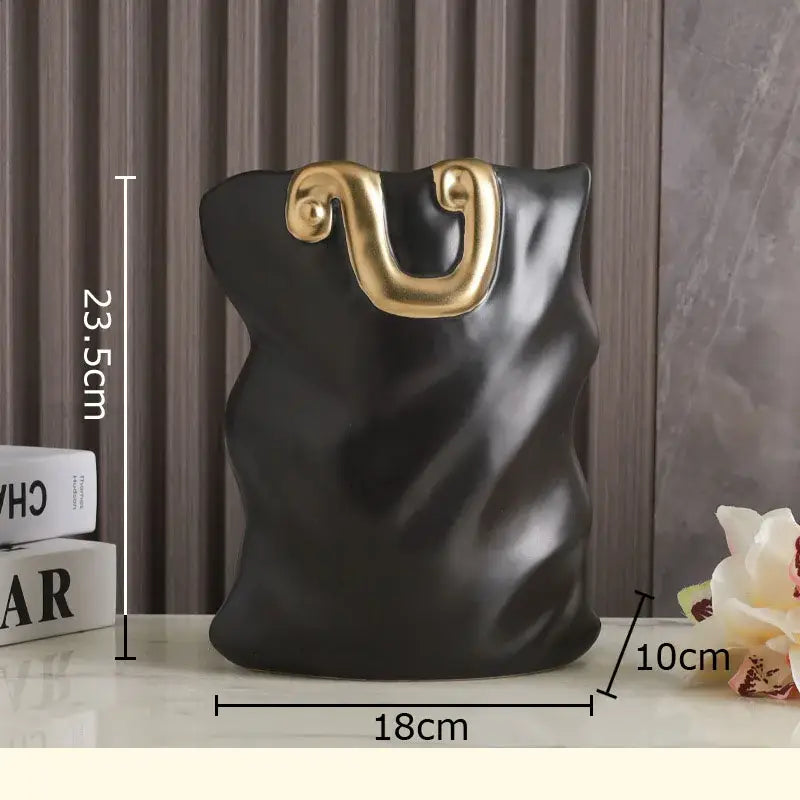 Modern black and gold ceramic bag vase by decorbites featuring gold-tone handles for elegant living room decor