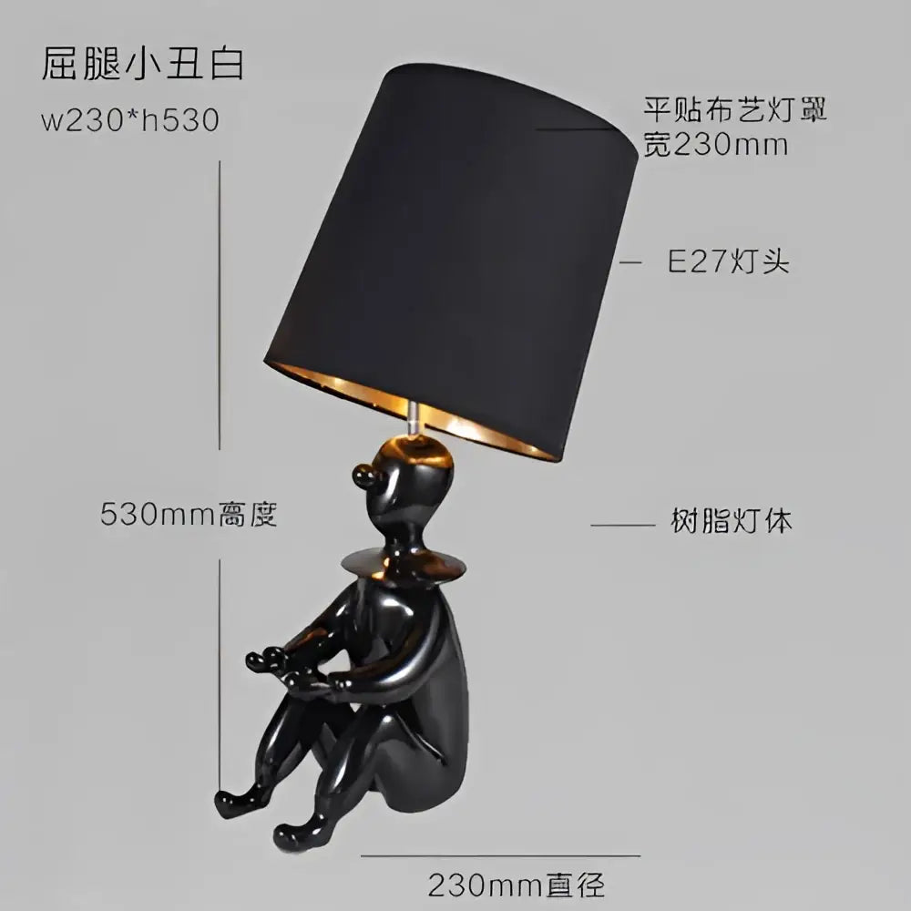 Modern black and gold ceramic clown desk lamp with glossy figurine base and matte black shade for bedroom decorbites clown desk