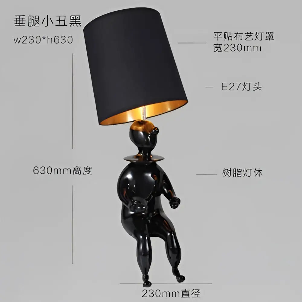 Modern black and gold ceramic clown desk lamp with a glossy figurine base and matte black shade with gold interior for decorbites clown desk