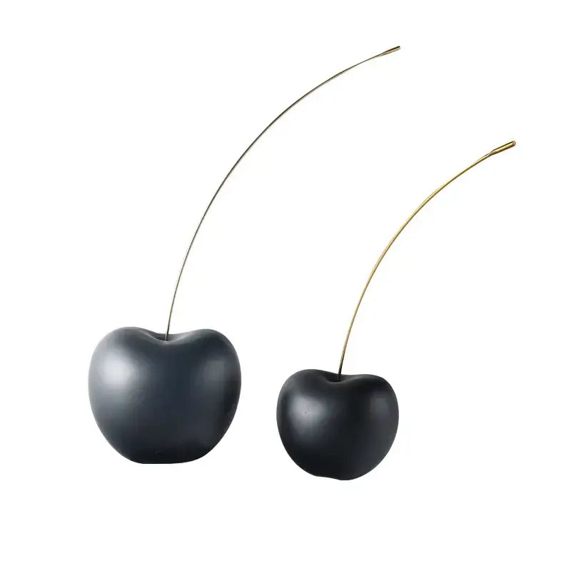 Two glossy black cherry resin sculptures with slender silver and gold metallic stems for modern living room decorbites decor