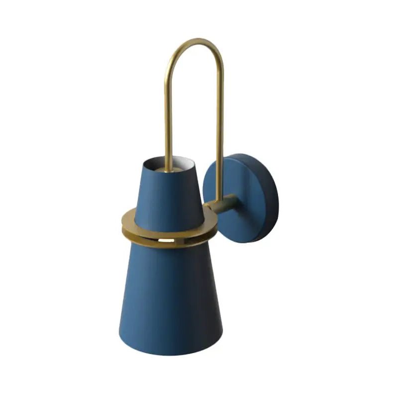 Modern dining room wall lamp featuring a blue sconce with brass accent and curved arm in a black and gold design