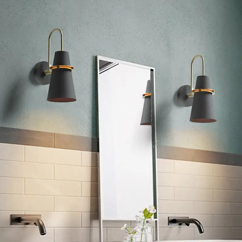 Modern black and gold conical sconce with wall mount design for elegant dining room lighting
