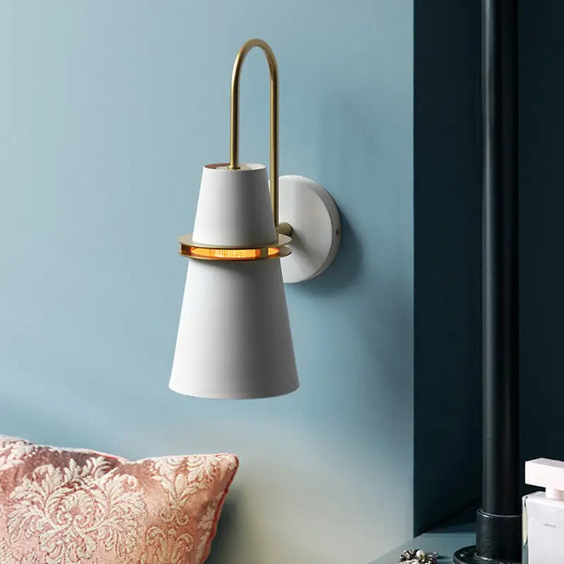 Modern black and gold conical dining room wall sconce with white shade brass arch and accent ring